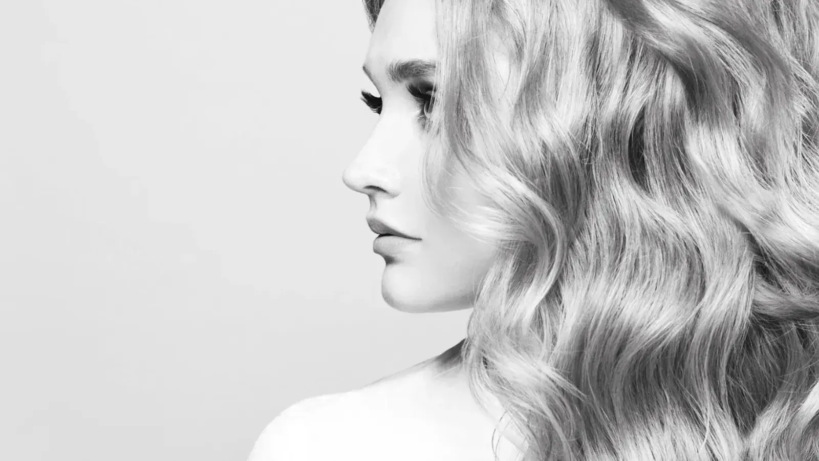 A black and white portrait of a finished blonde wave